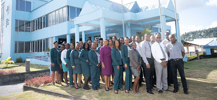 AID Bank staff gathered in front of the Bank's headquarters